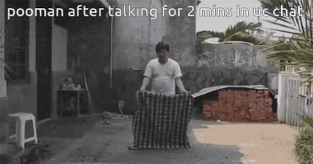 a man is holding a blanket in front of a building with the words pooman after talking for 2 mins in uc chat below him