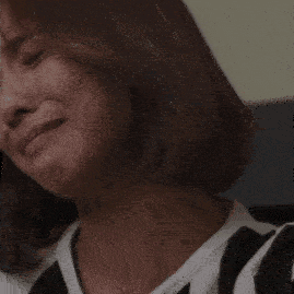 a close up of a woman 's face with her eyes closed and her mouth open