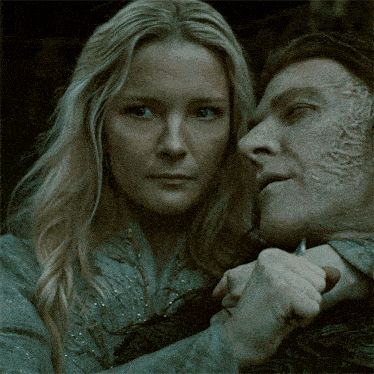 a woman holds a knife to a man 's throat