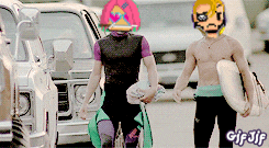 a gif of a man holding a surfboard with a cartoon face on his face
