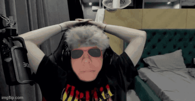 a person wearing sunglasses and a shirt that says ' nirvana '