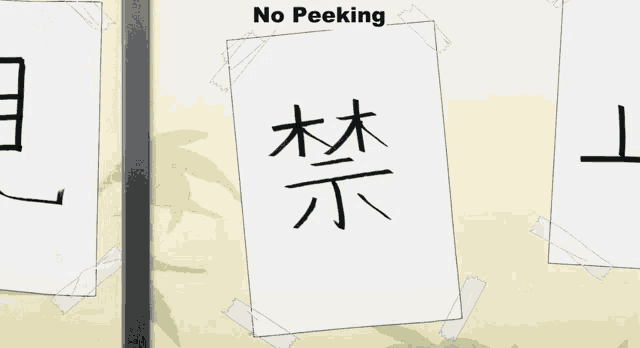 a sign that says no peeking is taped to a door