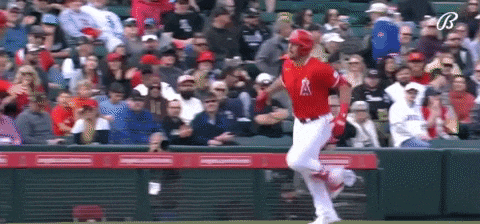 a baseball player is running on the field during a game .