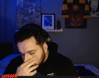 a man with a beard wearing headphones and a black shirt that says t on it
