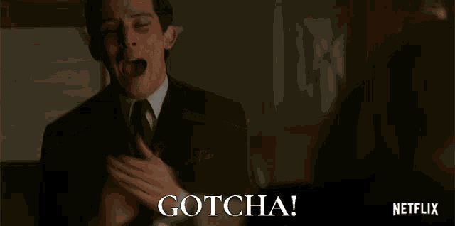 a man in a suit and tie says gotcha in a netflix advertisement