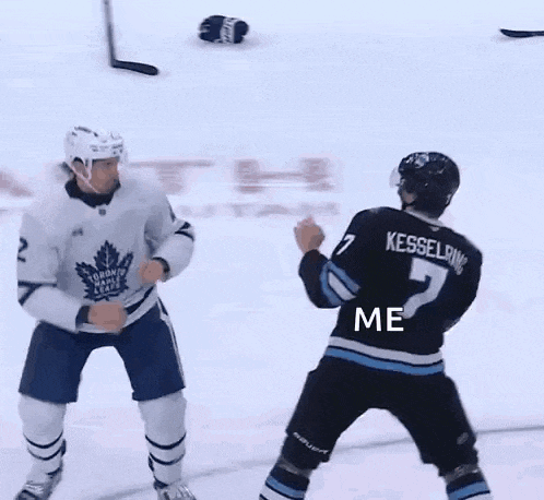 two hockey players are fighting on the ice and one of them has the word me on his back .