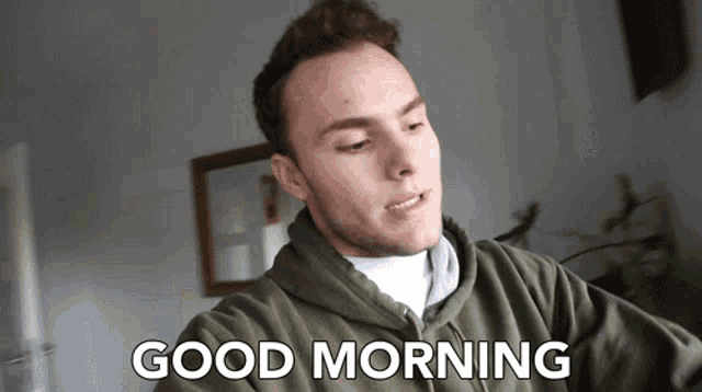 a man in a green sweatshirt says good morning