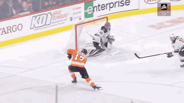 a hockey game is being played in front of a sign that says kdi