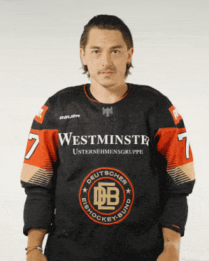 a man wearing a black and orange jersey that says westminster on it