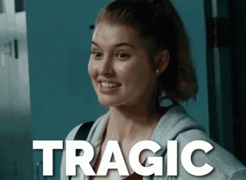 a woman is smiling in front of a sign that says tragic on it