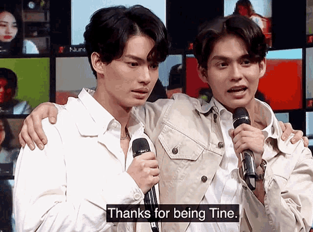two men holding microphones with the words thanks for being tine on the bottom