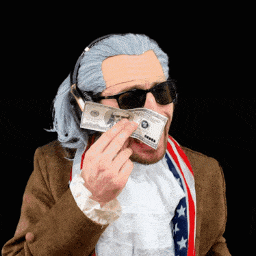 a man wearing a wig and sunglasses is holding a 100 dollar bill in front of his face