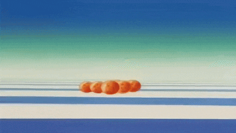 a row of oranges floating in the air on a striped surface .