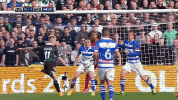 a soccer game is being played in front of a crowd and the score is 1-0