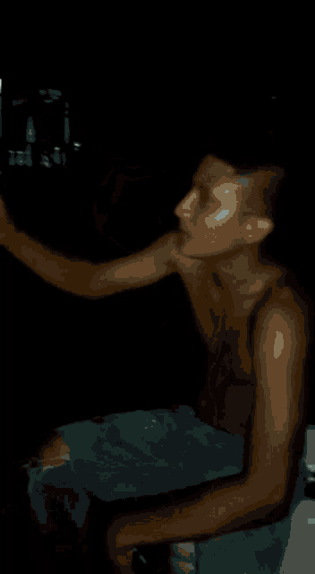 a man without a shirt is holding a can of soda