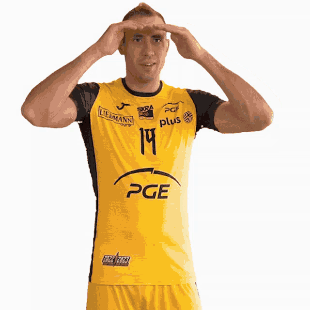 a man wearing a yellow shirt that says pge