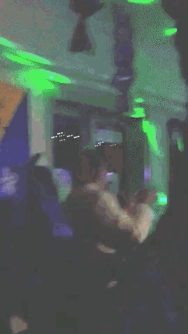 a blurry picture of a man in a dark room with a sign that says ' a ' on it