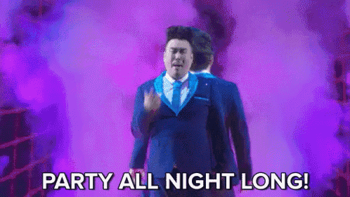 a man in a suit and tie is standing in front of a purple background and says party all night long .
