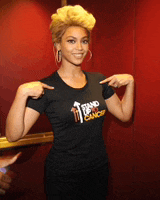 a woman wearing a black t-shirt that says " stand up for cancer "