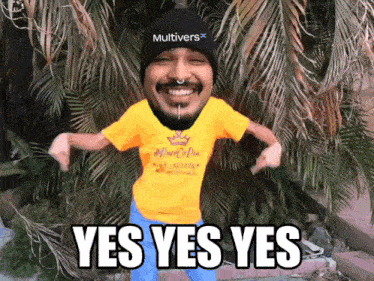 a man wearing a yellow shirt that says " yes yes yes " on it