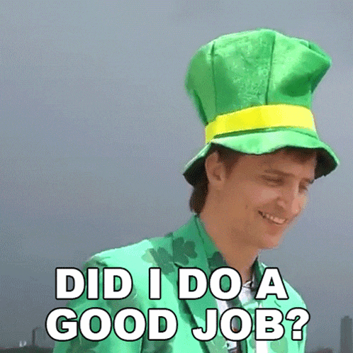 a man wearing a green leprechaun hat is smiling and asking " did i do a good job "