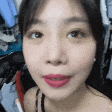 a close up of a woman 's face with a red lip