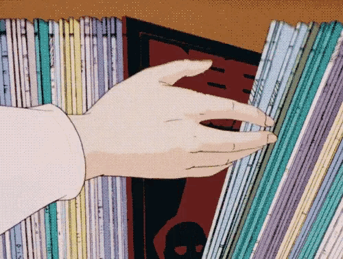 a person 's hand is reaching into a stack of records