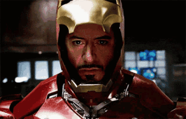a man with a beard wearing a red and gold iron man suit