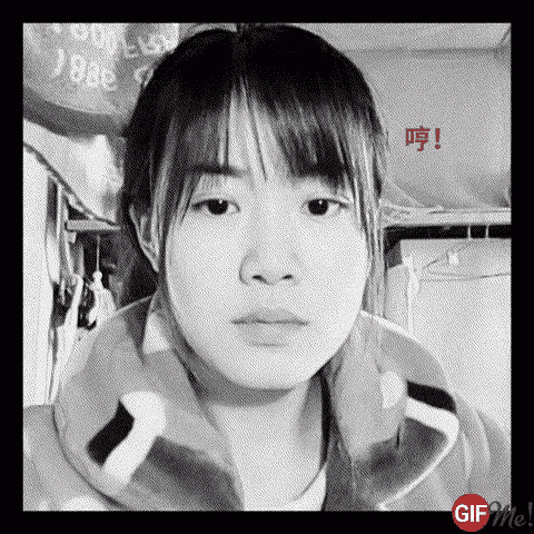 a black and white photo of a young girl making a face .