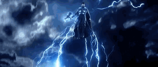 thor is flying through the air while holding a hammer in his hand .