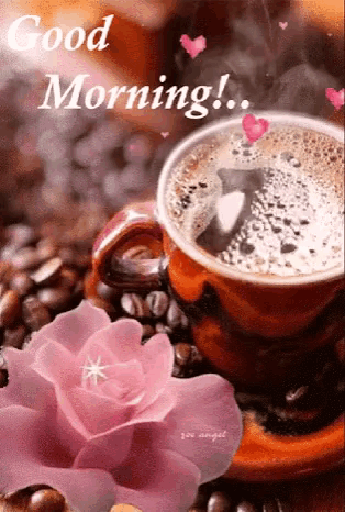 a cup of coffee with a pink rose and coffee beans on a saucer .