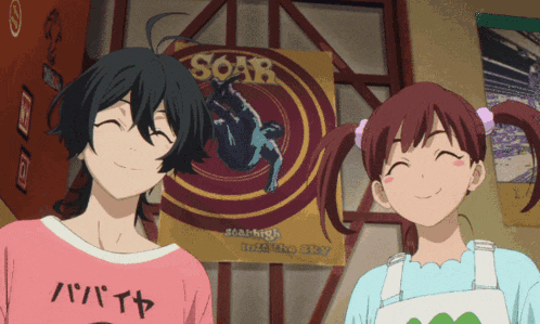 a boy and a girl are smiling in front of a sign that says soar
