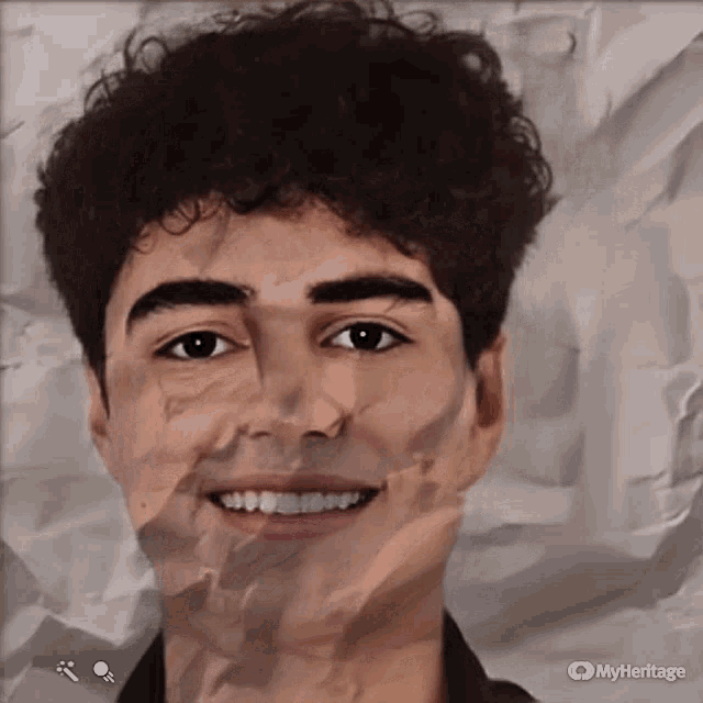 a young man with curly hair is smiling on a piece of crumpled paper with the watermark myheritage