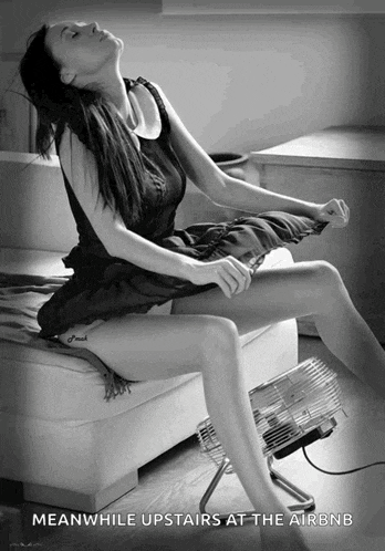 a black and white photo of a woman sitting on a couch with the words meanwhile upstairs at the airbnb below her