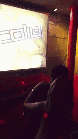 a man sits in front of a screen that says ' aolg ' on it
