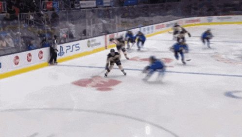 a hockey game is being played on a rink with a ps5 advertisement on the wall
