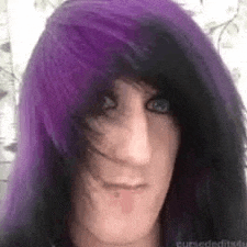 a close up of a person with purple and black hair .