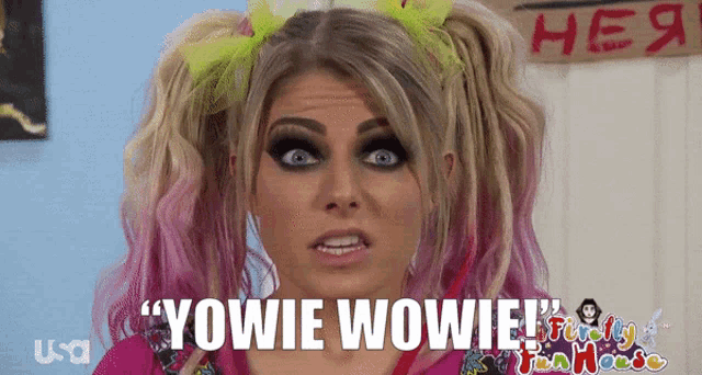 a woman with pigtails and a sign that says " yowie wowie " on it