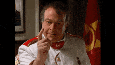 a man in a white and red uniform with a red hammer and sickle on his chest