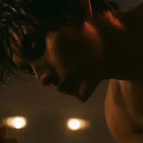 a close up of a man 's face with water coming out of his mouth