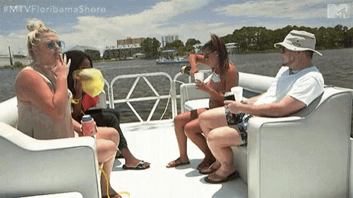a group of people are sitting on a boat in the water with the hashtag #mtvfloridamashore