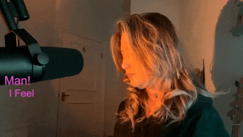 a woman in front of a microphone with the words man i feel