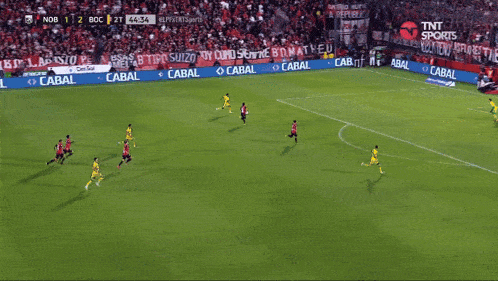 a soccer player is running on the field in front of a sign that says tnt sports live