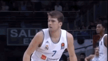 a basketball player wearing a number 7 jersey is standing on the court