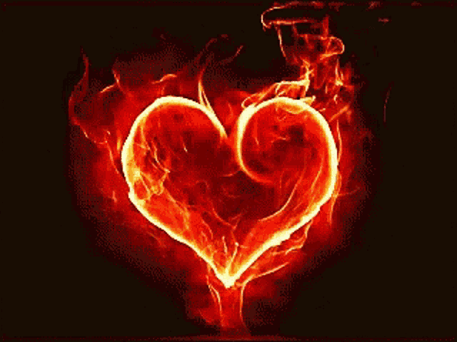 a red heart is surrounded by flames and smoke