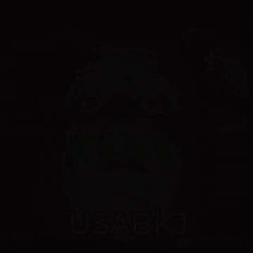 a man holding a shot glass with usabkj written above him