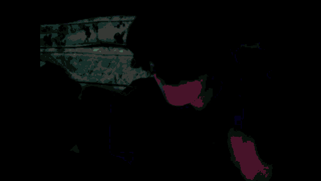 a man in a black shirt is standing in a dark room with a blue light behind him