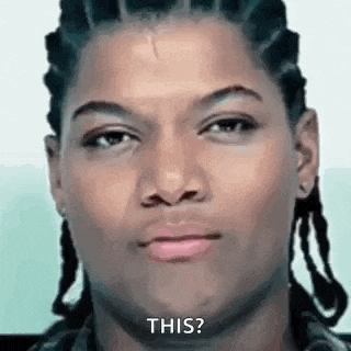 a man with dreadlocks is making a funny face and saying `` this '' .