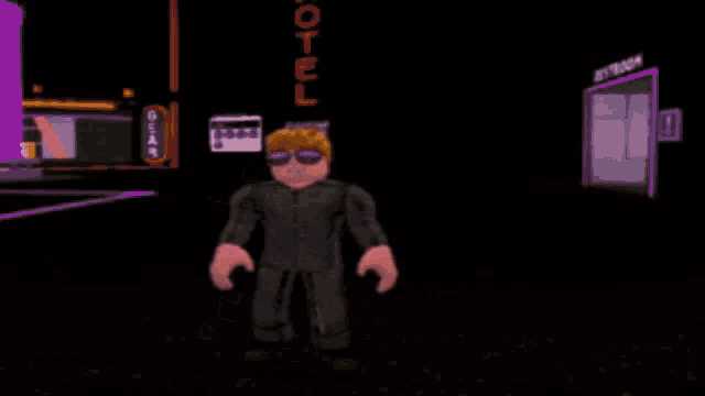 a man is standing next to a purple robot in a dark room .