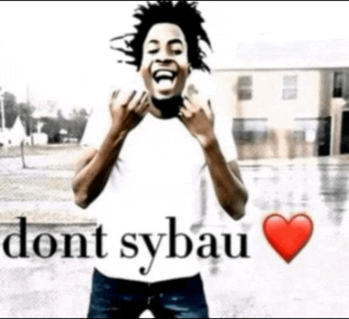 a man in a white shirt is laughing with the words " dont sybau " behind him
